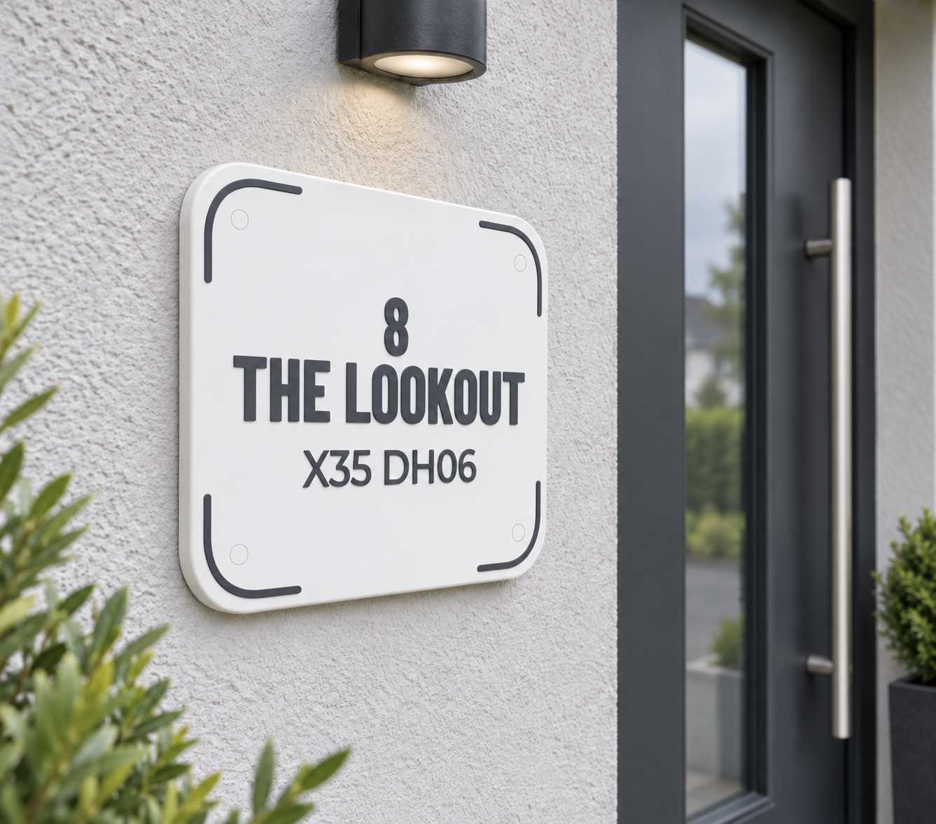 White EirPlate house sign for The Lookout mounted beside a dark front door